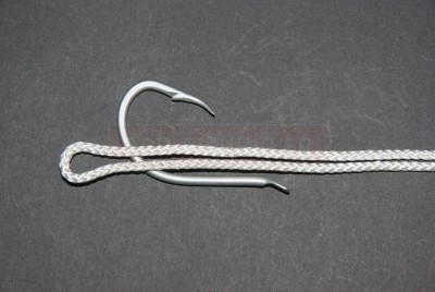 Formez une double ligne et placez la sur la hampe, palette vers la bas. La longueur de cette double ligne dépendra de la taille de l\'hameçon et du diamètre du fil ( plus celui-ci sera important, plus votre double ligne sera grande) Pensez aussi qu\'il vous faut suffisamment de fil pour repasser dans la boucle.